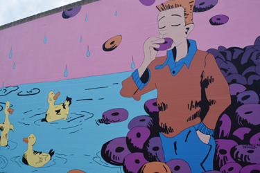Mural in Hamilton, Ohio with a Man Eating a Donut.